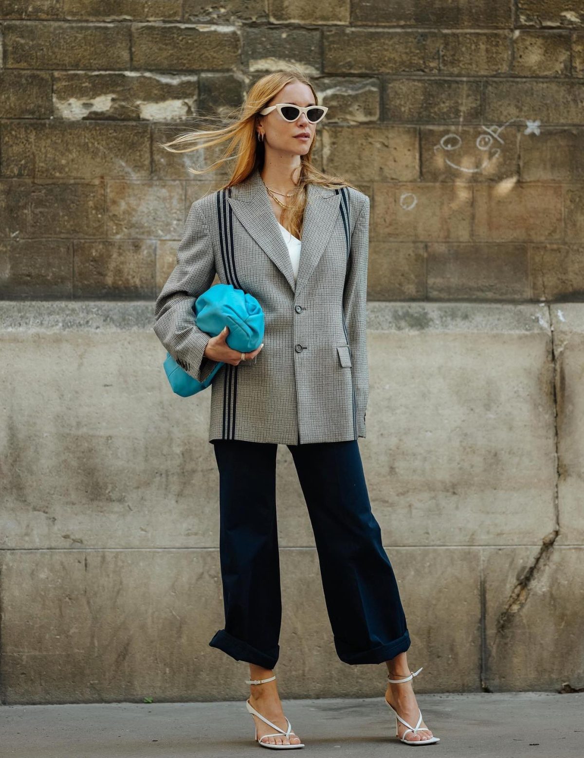 Navy blue culottes with a structured grey blazer and white strappy heels.