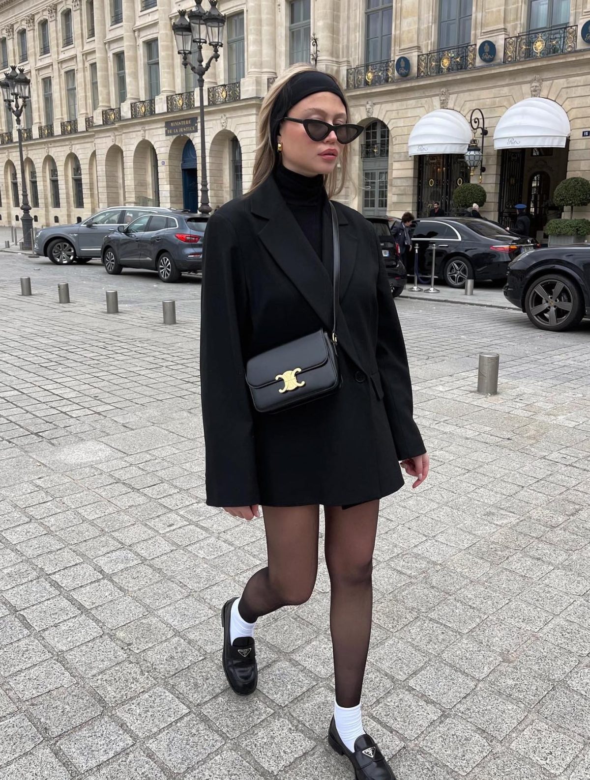 Preppy black blazer outfit with mesh tights, white socks and Prada loafers.