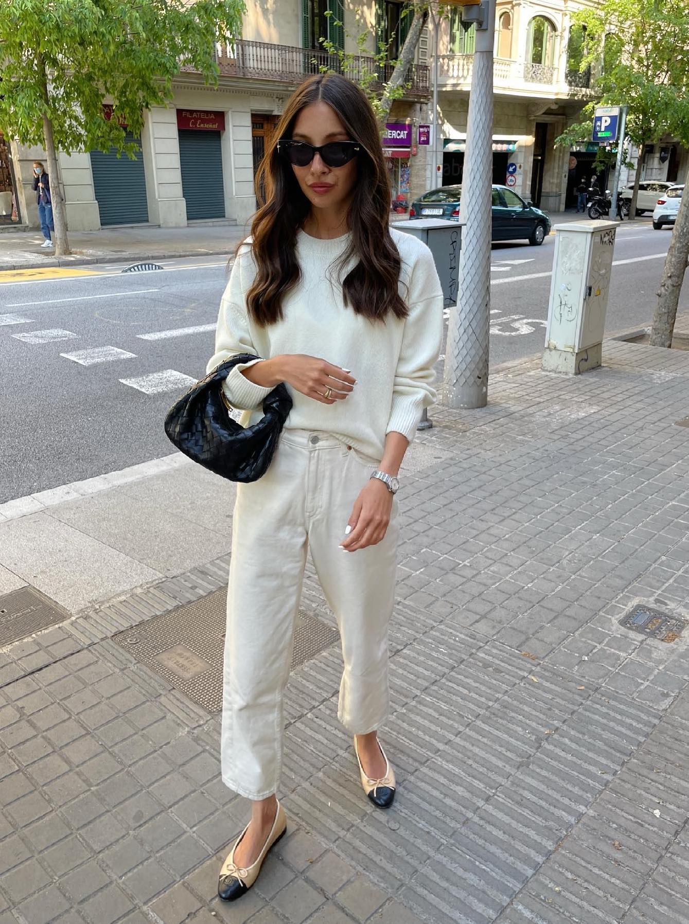 All white outfit with ankle length white jeans, sweater and black mini Jodie bag.